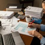 Person reviewing tax documents at a desk, symbolizing IRS audit preparation
