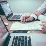 Business owner reviewing bank statements for monthly bank account reconciliation