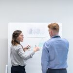 Business owner reviewing KPI dashboard and performance metrics on screen
