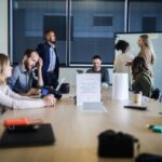 Business advisors reviewing mergers and acquisitions deal structure and due diligence documents