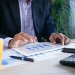 Utah small business owner reviewing financial reports including income statement and balance sheet with a CPA