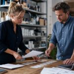 Small business owner and accountant planning incoming and outgoing cash flow